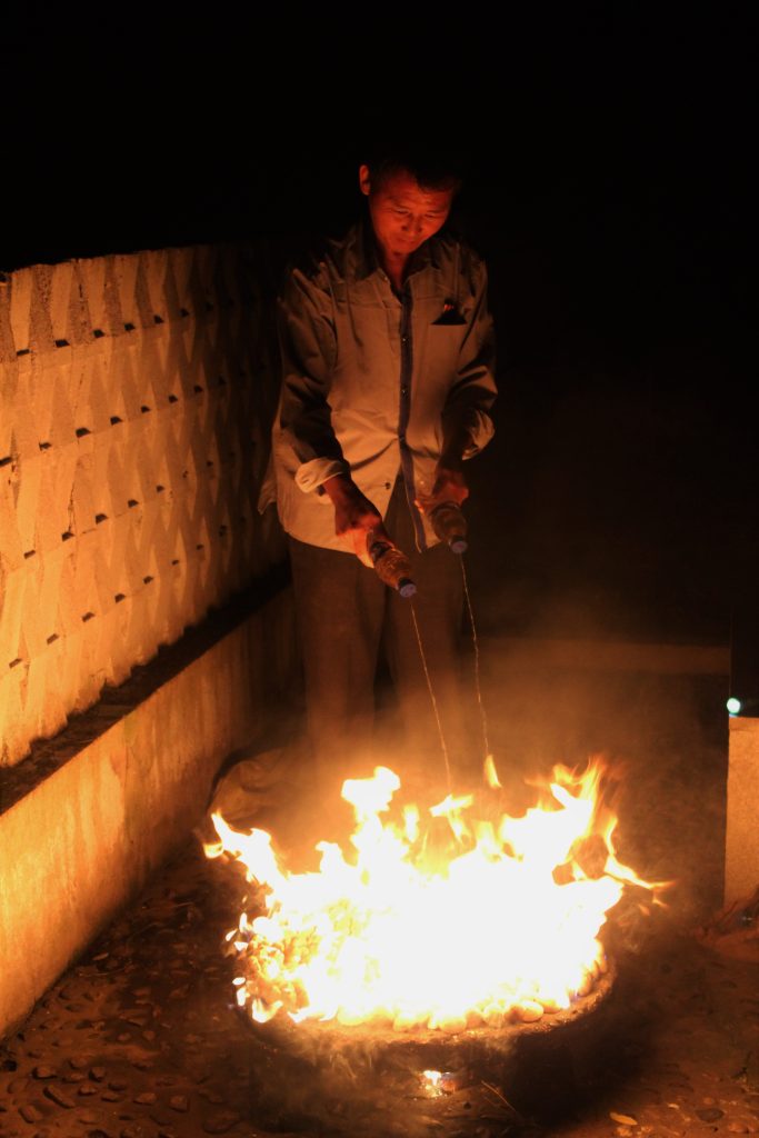 Our North Korean guide adding petrol to the clams.