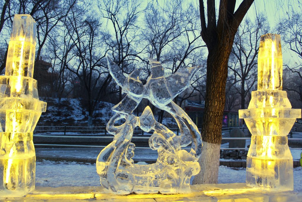 A sculpture that is illuminated just before it is fully dark