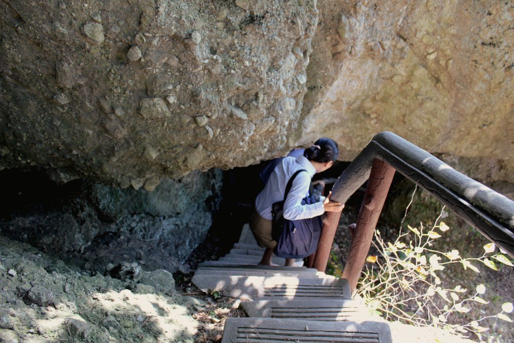 A staircase leading underneath some rocks