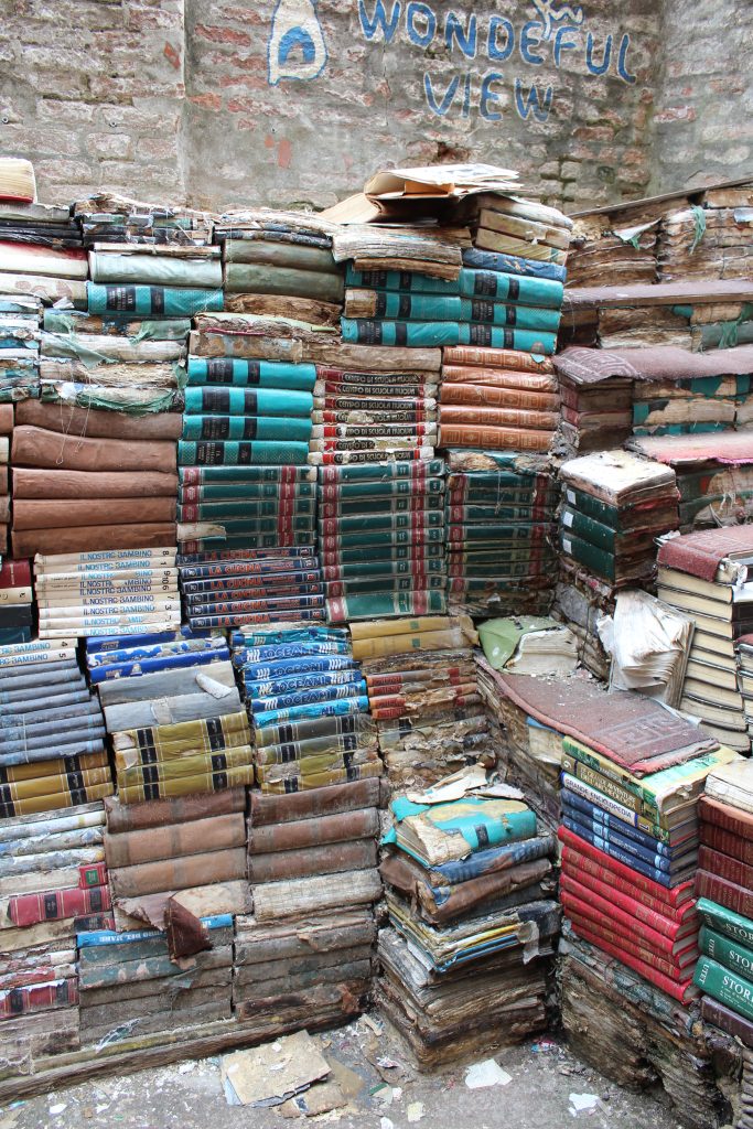 A stack of books to climb with the words "wonderful view" and an arrow painted above them.