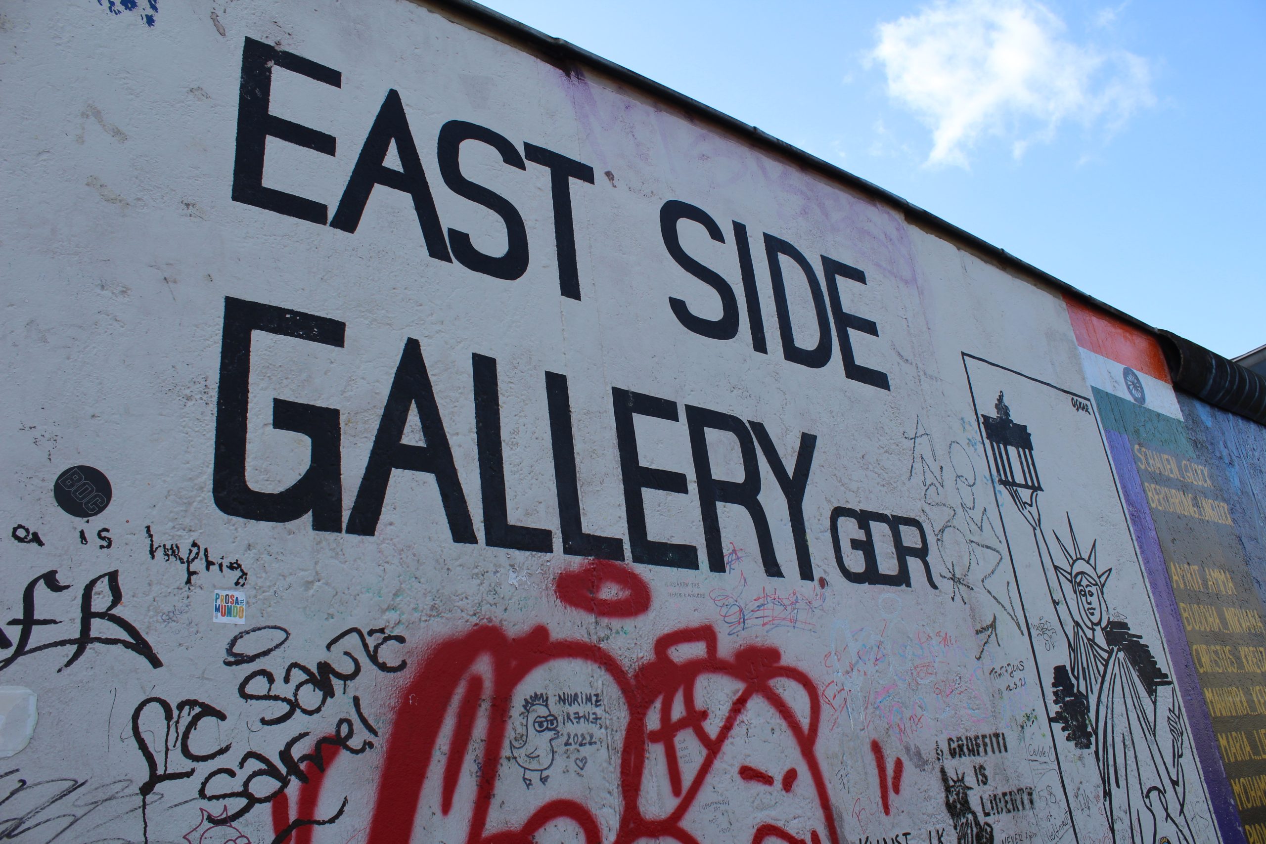 Photo of the Berlin Wall that reads "East Side Gallery" surrounded by graffiti.