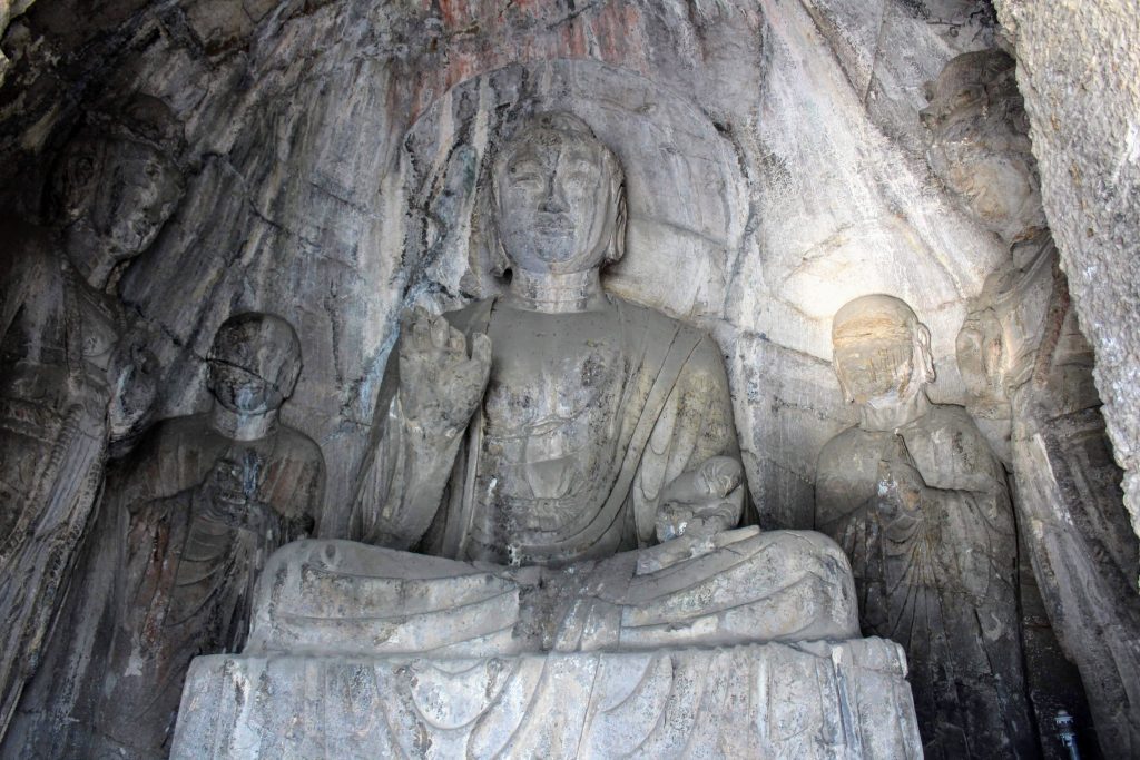 An Amitabha Buddha statue surrounded by four other smaller statues.