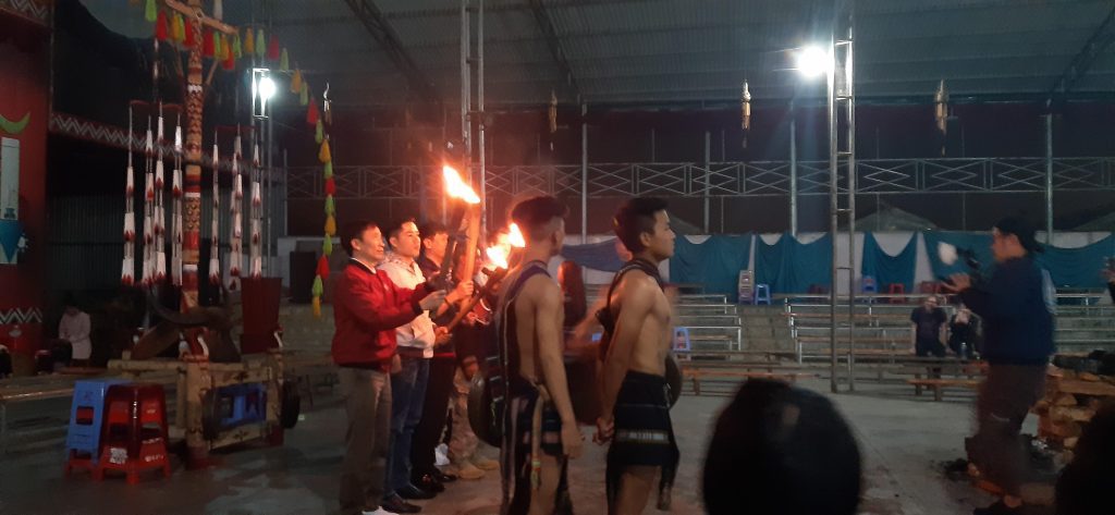 Photo of several men holding lit torches ready to start the Gong Show