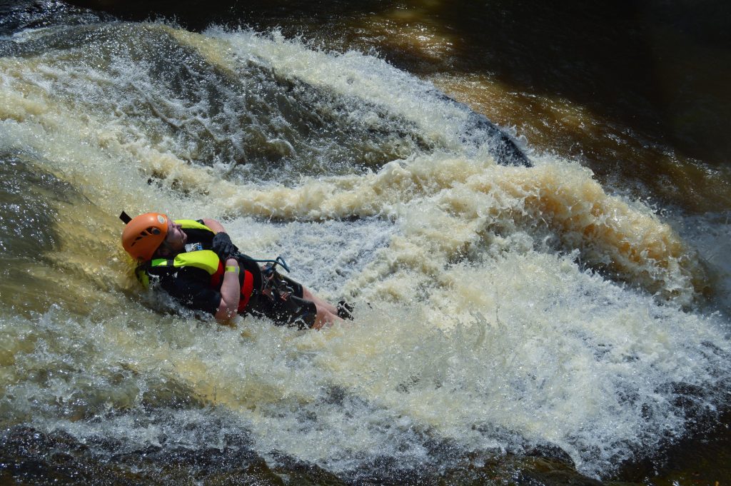 Photo of me sliding down rocks at a small waterfall.