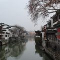Photo of river in Nanjing with houses lining either side.