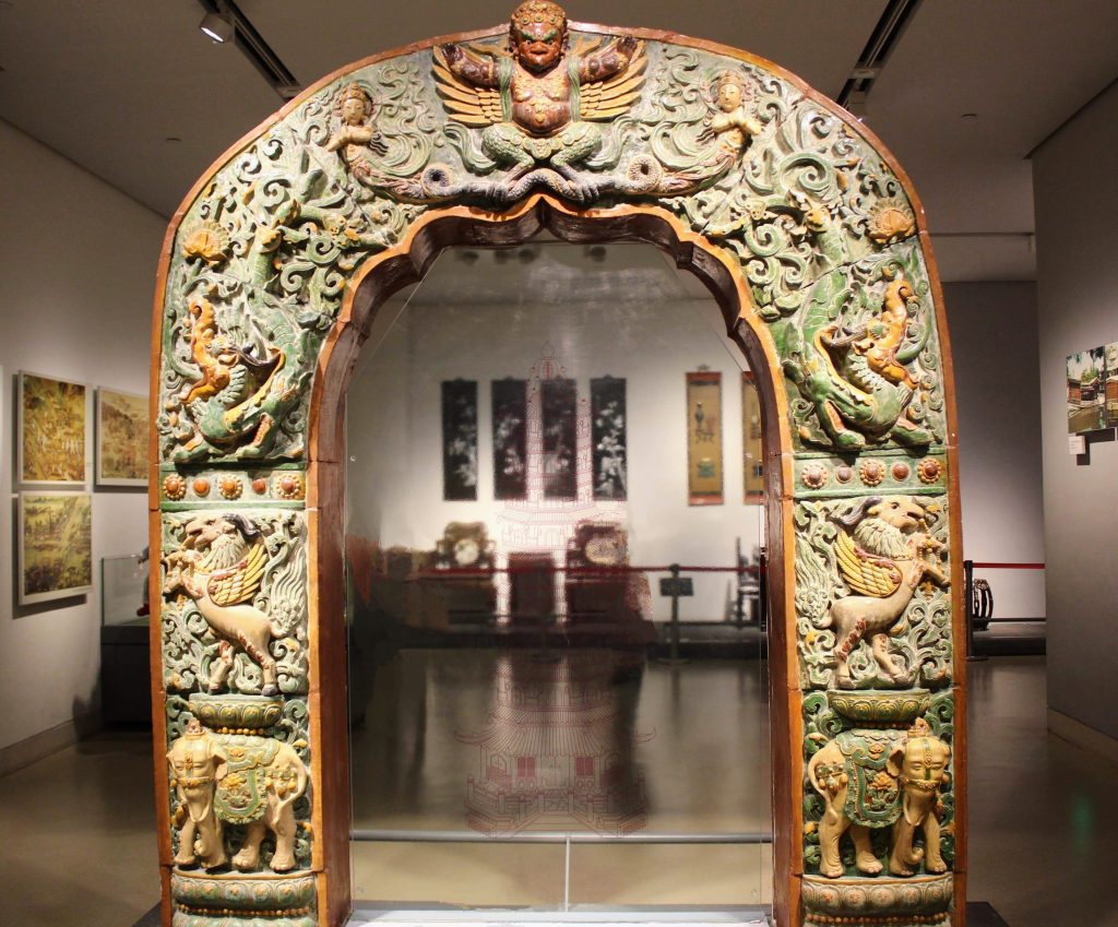 Photo of arched doorway with many animal carvings.