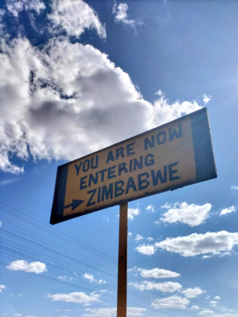 Photo of a sign saying "You are now entering Zimbabwe".