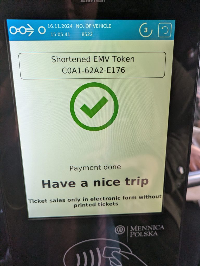 Photo of a screen that says "Payment done. Have a nice trip" with a big green tick. Underneath it says Mennica Polska and has the contactless symbol.